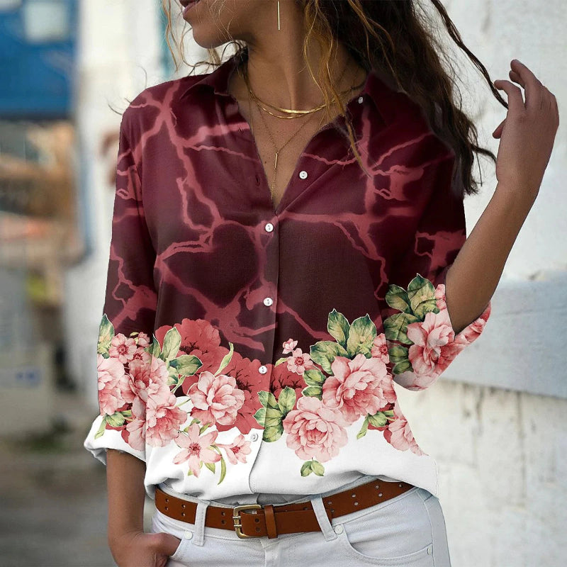 Woman wearing a maroon shirt with floral patterns in an urban setting