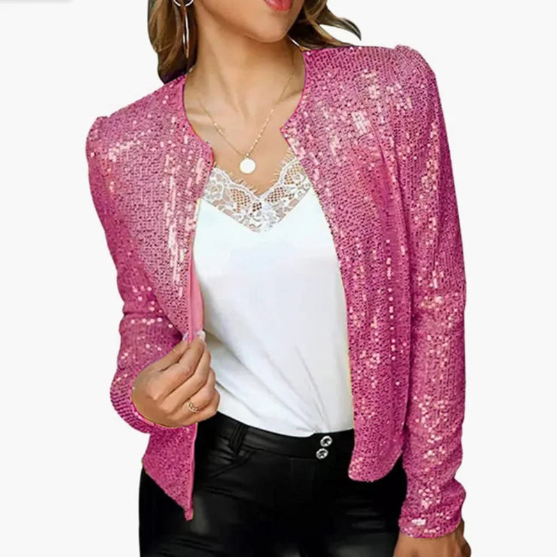 Pink sequin cardigan over a white top and black pants on a white background
