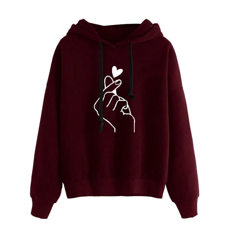 Maroon hoodie with a white hand holding a heart design on a white background