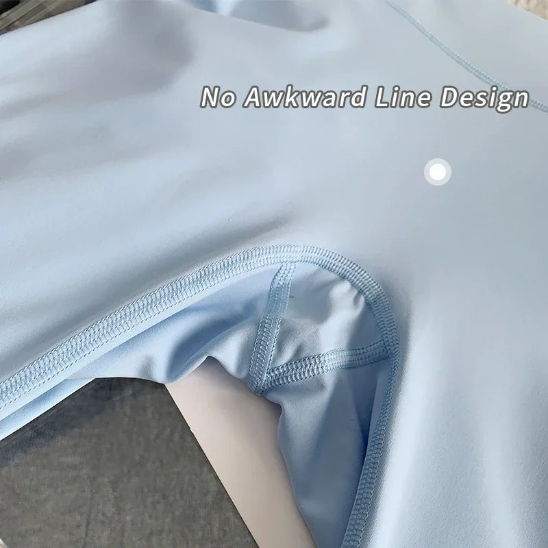 Light blue swimsuit with a close-up of the waistband on a neutral background.