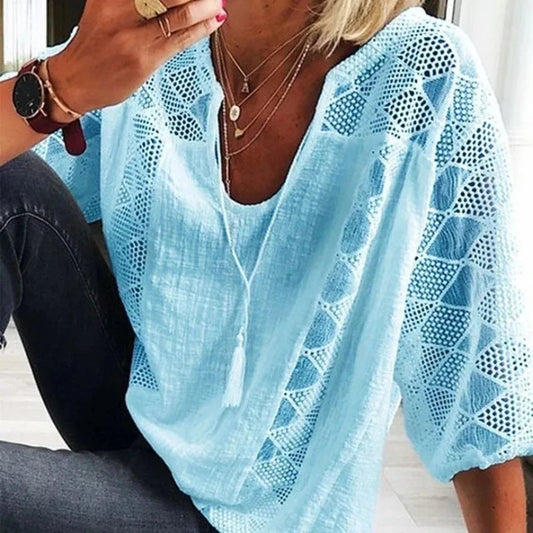 Light blue lace top worn by a person, with a focus on the garment.