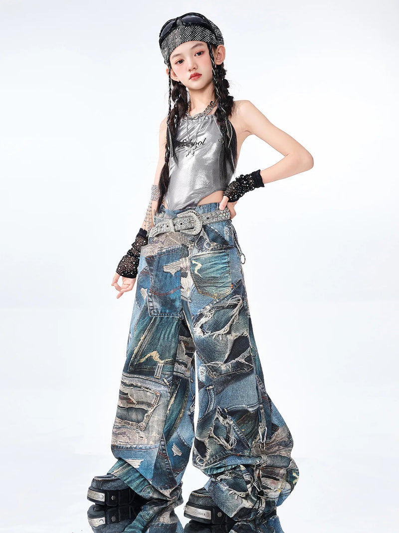 Person wearing a silver top and blue patchwork pants on a white background