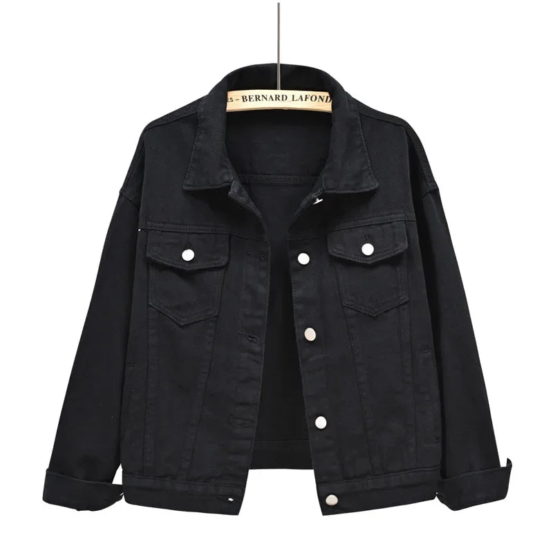 Black denim jacket on a hanger with a white background