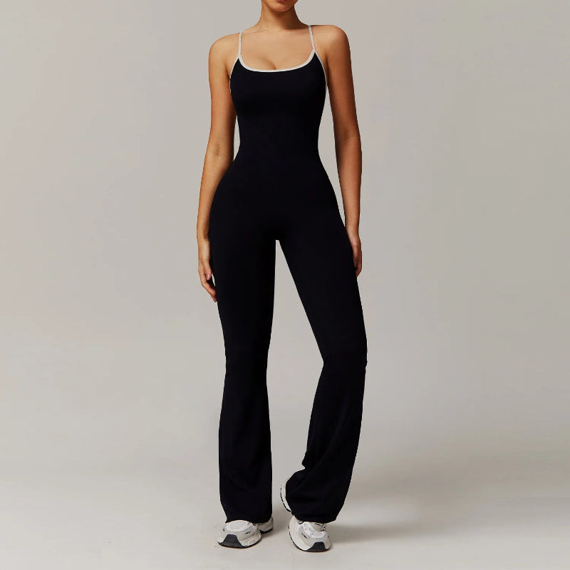 Person wearing a black jumpsuit with white trim on a plain background