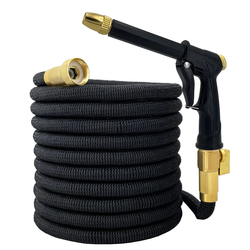Black expandable garden hose with gold nozzle and spray gun on a white background