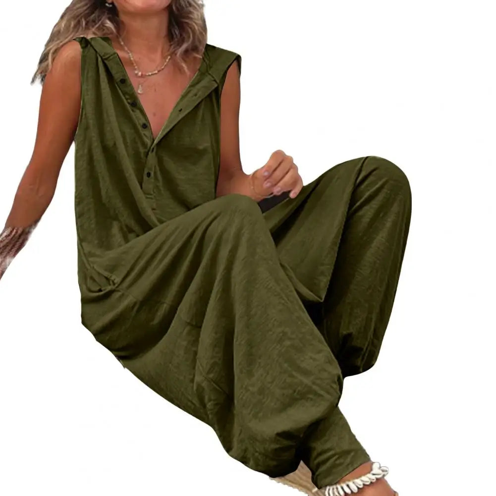 Woman wearing a green jumpsuit sitting on a white background