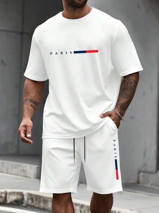 Person wearing a white t-shirt and shorts with 'PARIS' and flag design.
