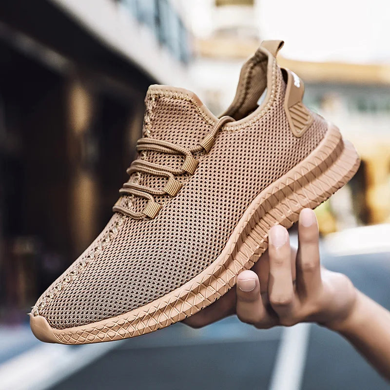 Brown sneaker held in a hand with a blurred background