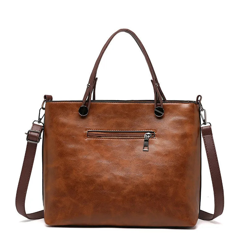 Brown leather handbag with a shoulder strap on a white background