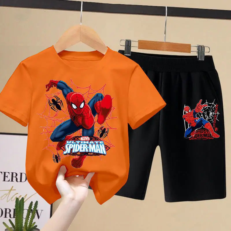 Orange t-shirt with Spider-Man graphic and black shorts on a hanger against a beige background.