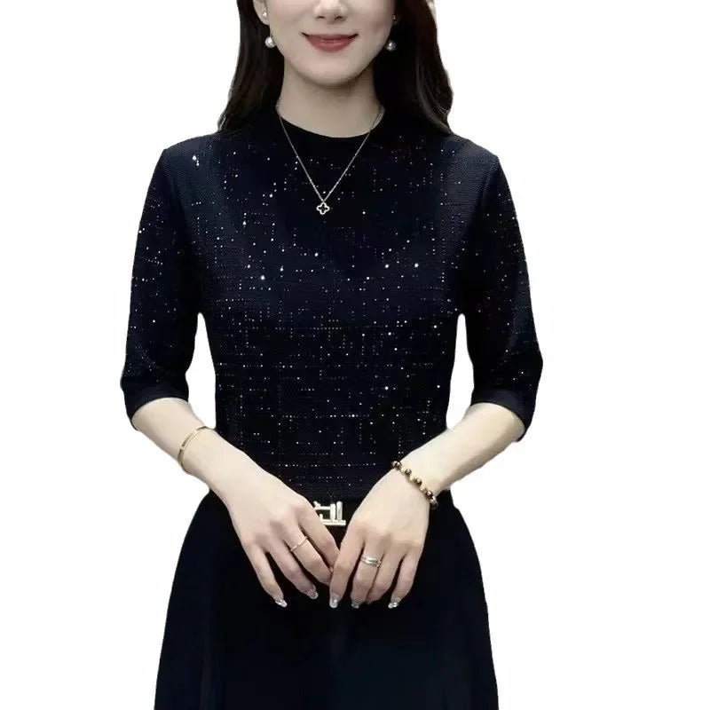 Woman wearing a dark blue dress with a subtle pattern on a white background