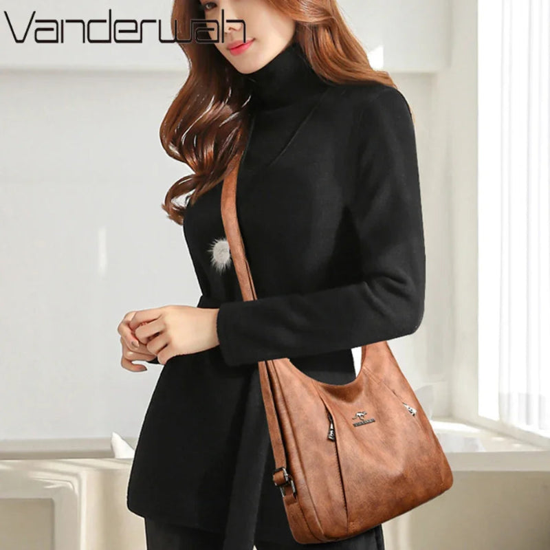Woman holding a brown leather handbag with a blurred indoor background