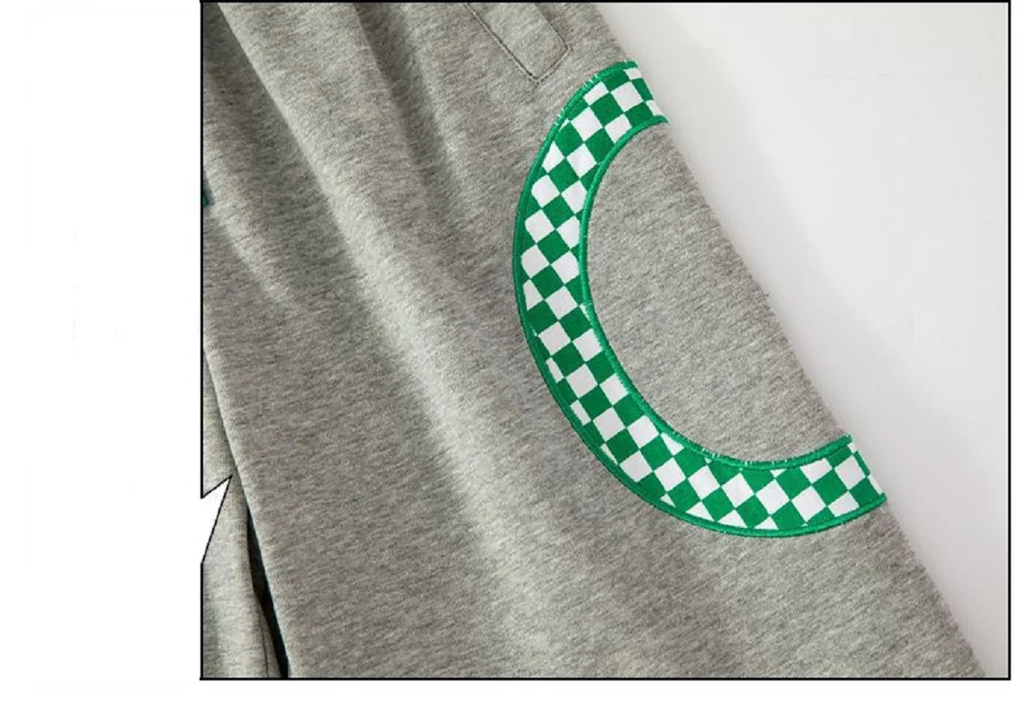 Gray sweatshirt with a green and white checkered pattern on a light gray background