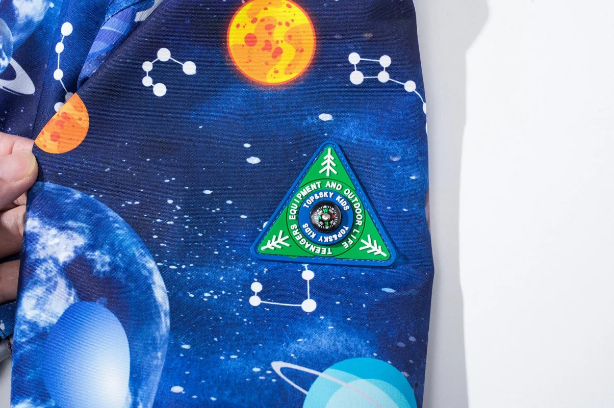 Space-themed poster with planets and a green triangle patch held by a hand.
