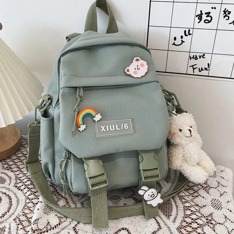 Light green backpack with decorative patches on a lace tablecloth