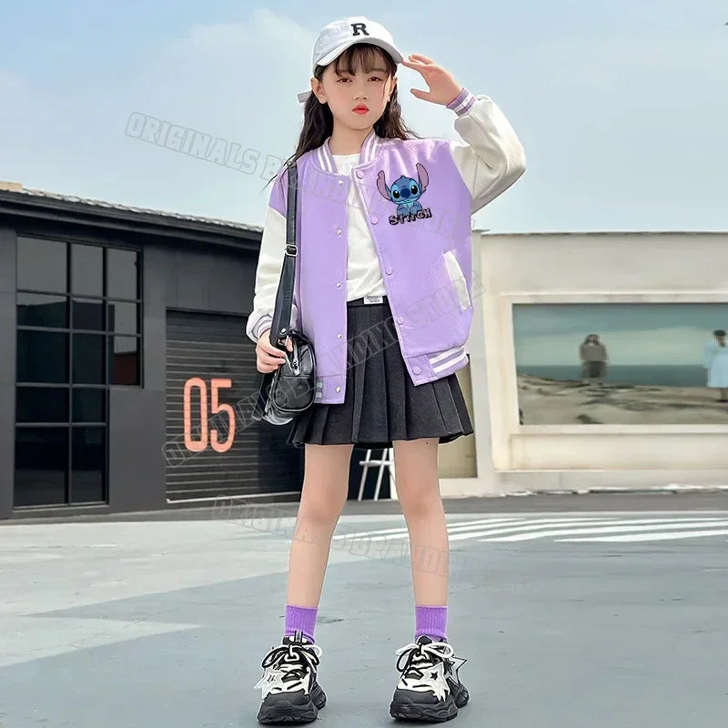 Person wearing a purple varsity jacket with a character design, white cap, and black skirt outdoors.