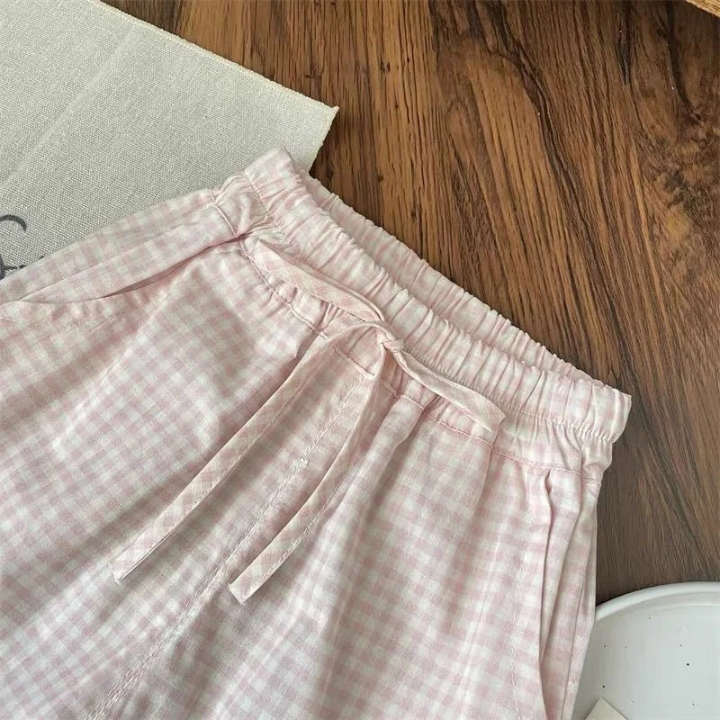 Pink checkered pants on a wooden floor