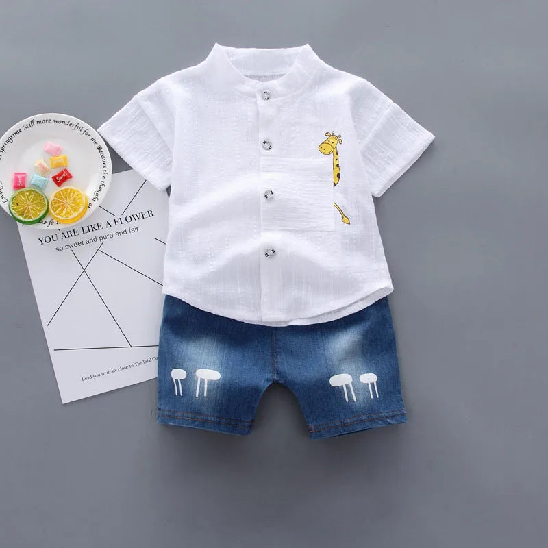 Children's outfit with white shirt and blue shorts on a gray background