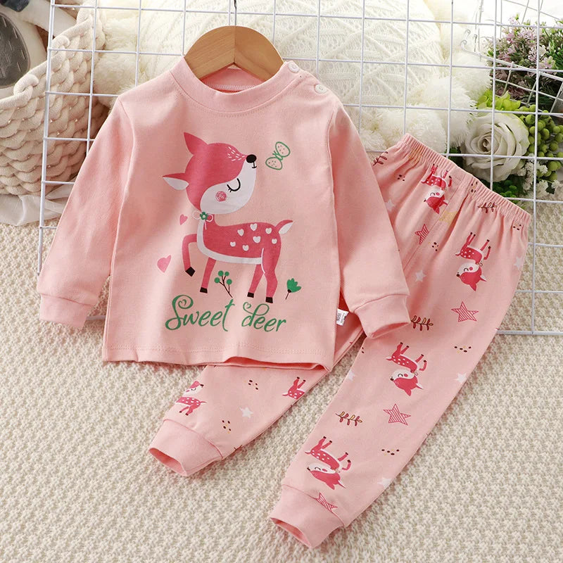 A baby girl's outfit set with long sleeves, featuring Minnie Mouse character designs, hanging on a wooden hanger.