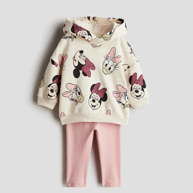Children's hoodie with cartoon character prints and pink pants on a light gray background