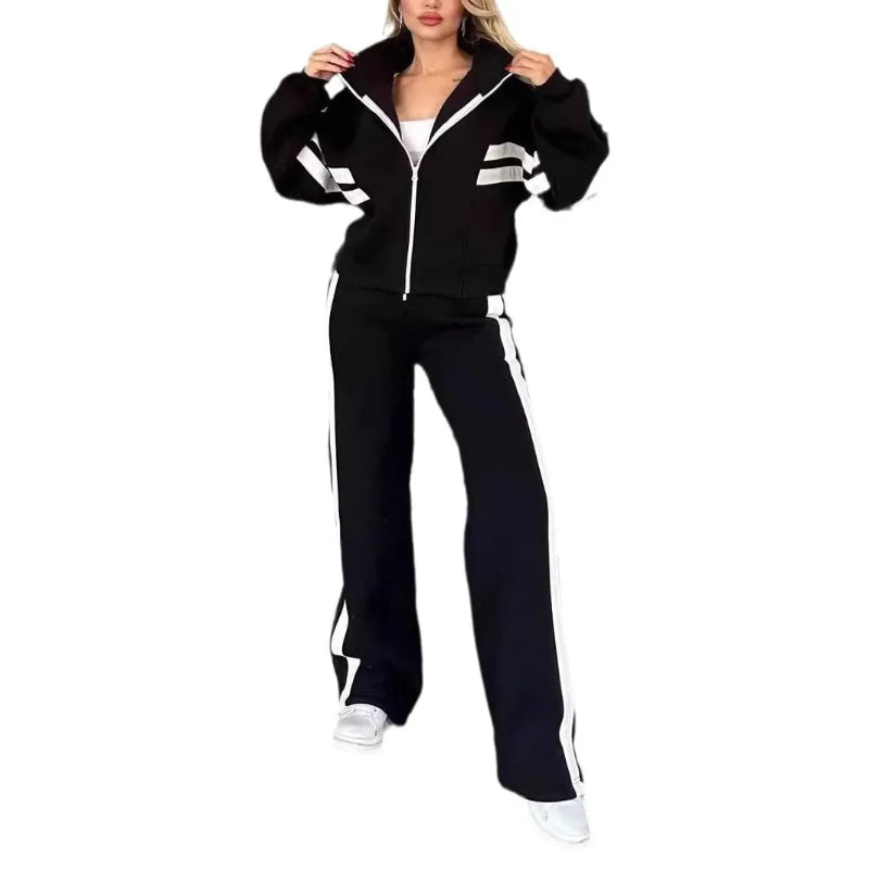 Person wearing a black tracksuit with white stripes on a white background