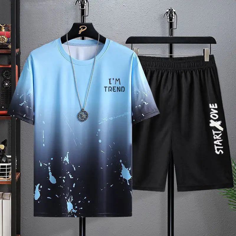 Blue t-shirt with 'I'm Trend' text and black shorts with 'Start Love' text on hangers against a gray wall.