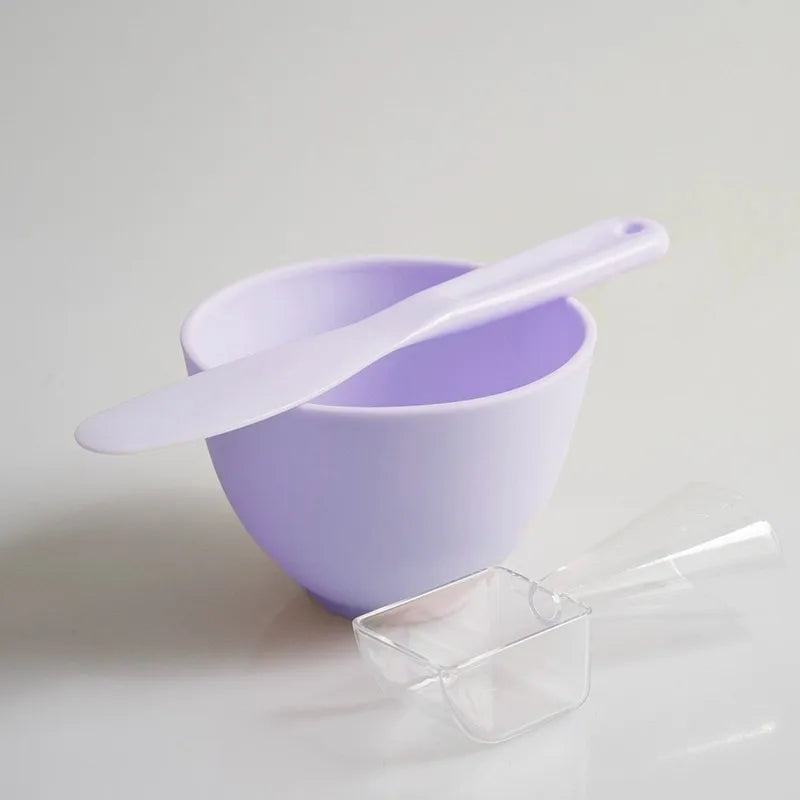 Purple bowl with a white spoon on a light gray background
