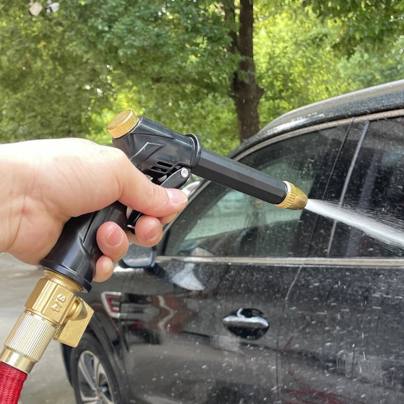 Person using a high-pressure washer to clean a car