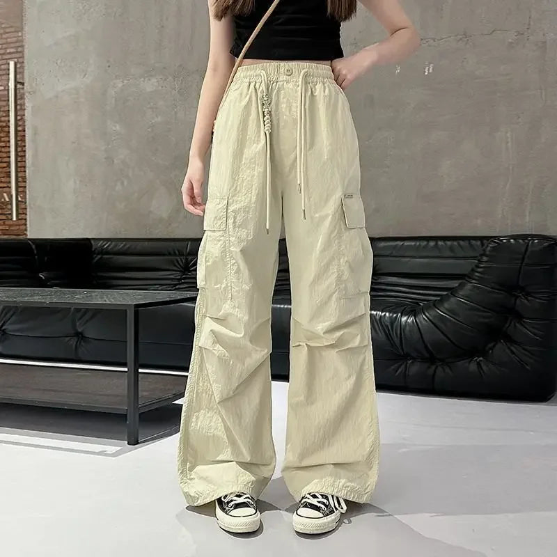 Person wearing beige cargo pants in an indoor setting