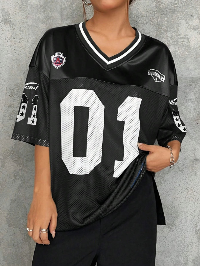 A woman wearing a black V-neck sports jersey with the number '01' on it. The jersey has white text and trim, and it appears to be made of polyester fabric.