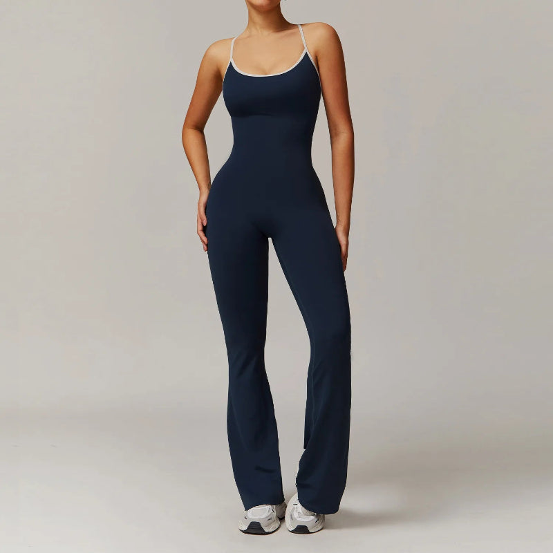 Person wearing a navy blue jumpsuit on a plain background