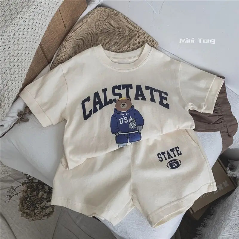 Beige t-shirt with 'CALSTATE' text and bear graphic on a textured surface