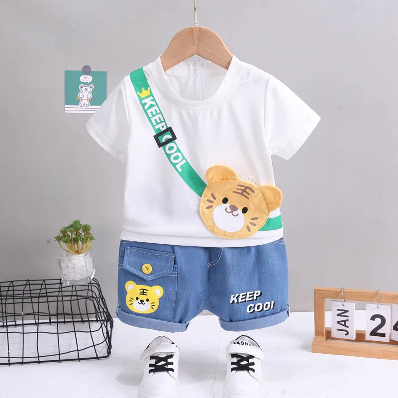 Children's outfit with white t-shirt, blue shorts, and bear design on a gray background