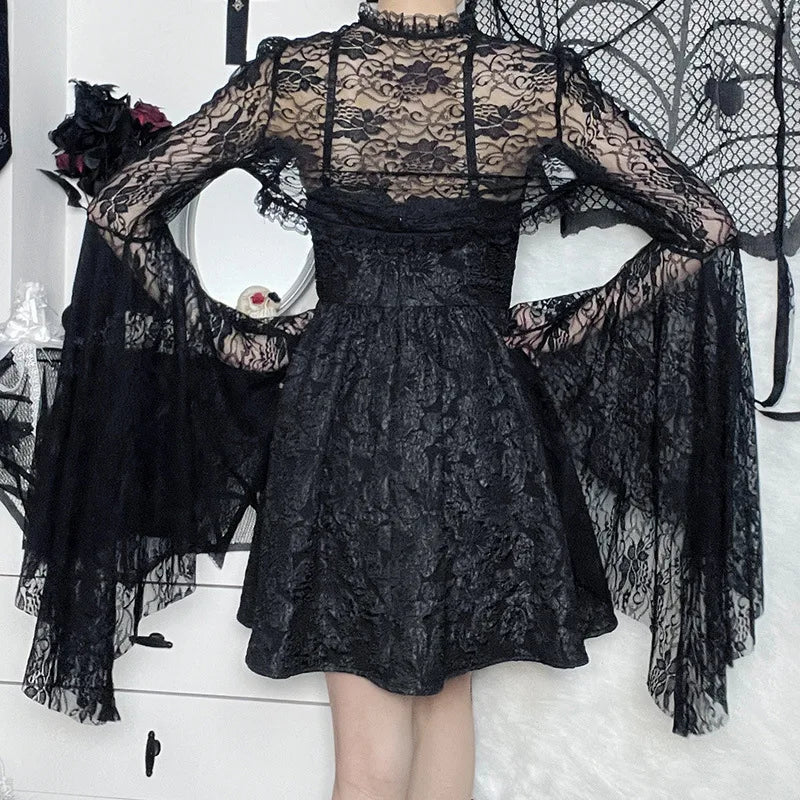 Black lace dress with sheer sleeves on a white background