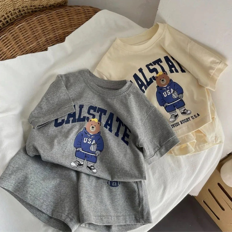 Gray sweatshirt and shorts set with bear graphic and 'CALSTATE' text, placed on a white surface.