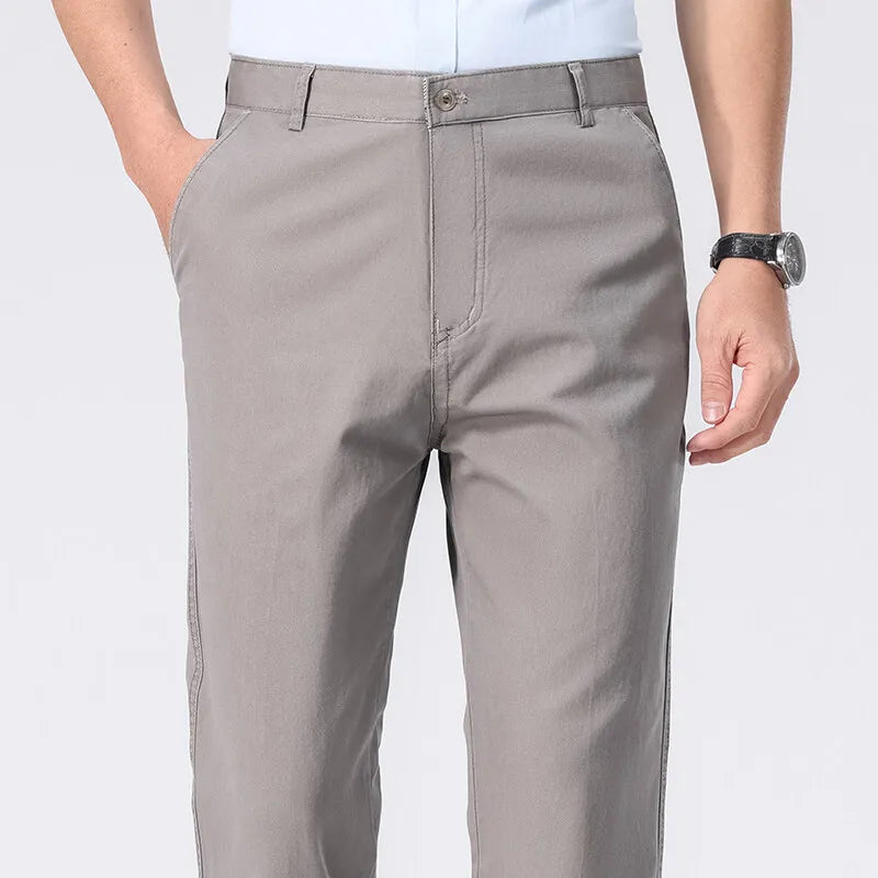 Gray pants worn by a person on a white background