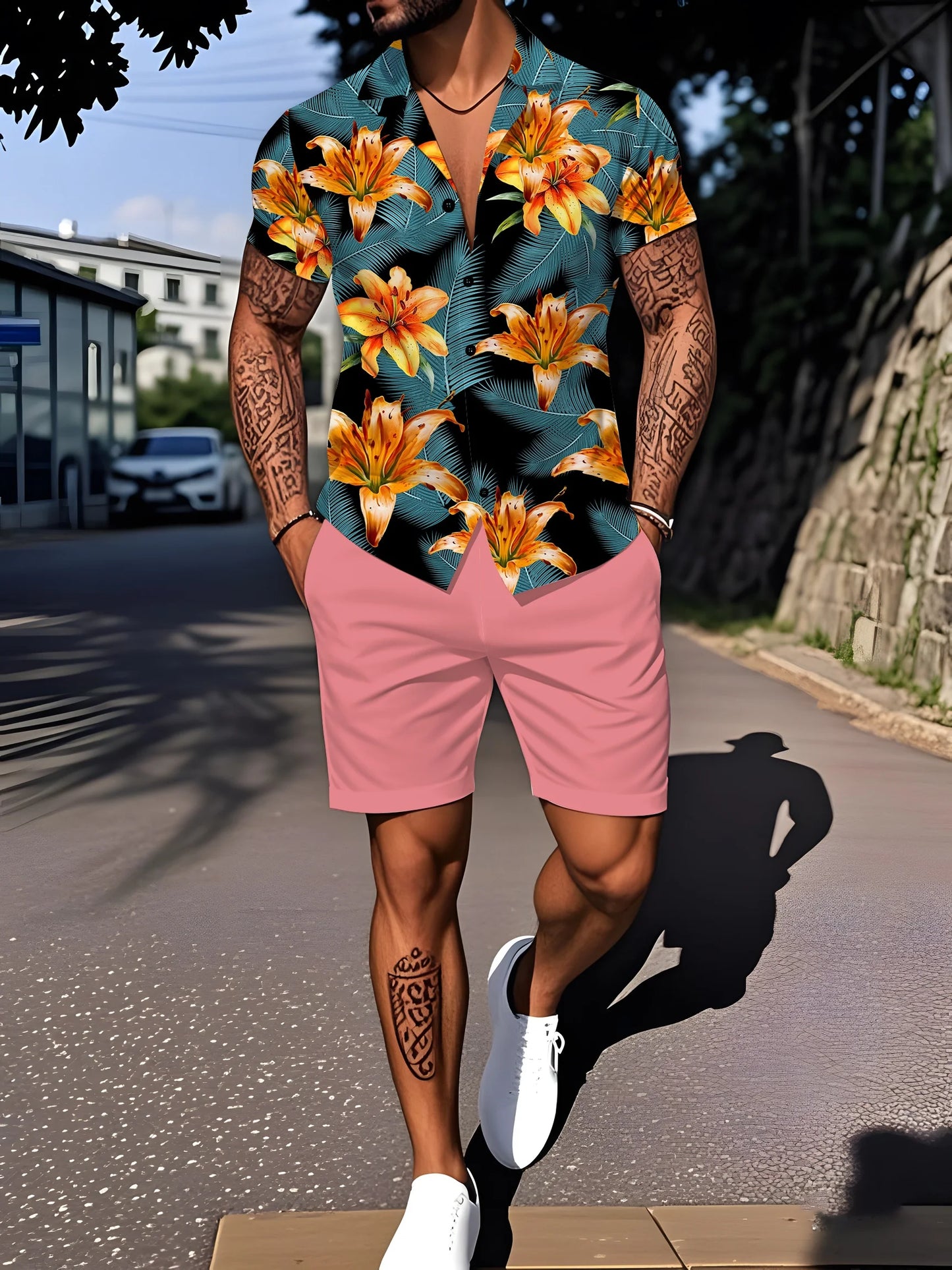 Person wearing a colorful floral shirt and pink shorts on a street.