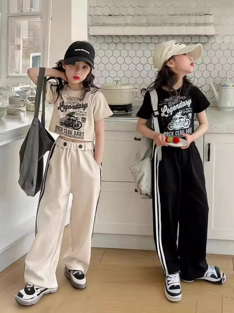 Two people in matching outfits with 'Legendary' graphic tees in a kitchen.