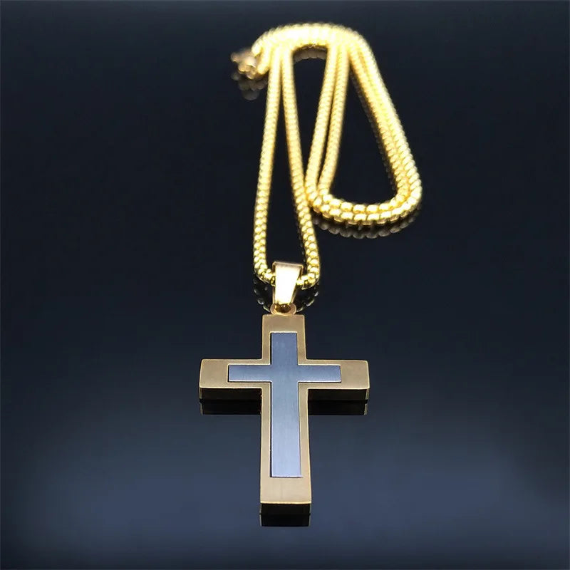 Gold cross pendant necklace on a dark background
