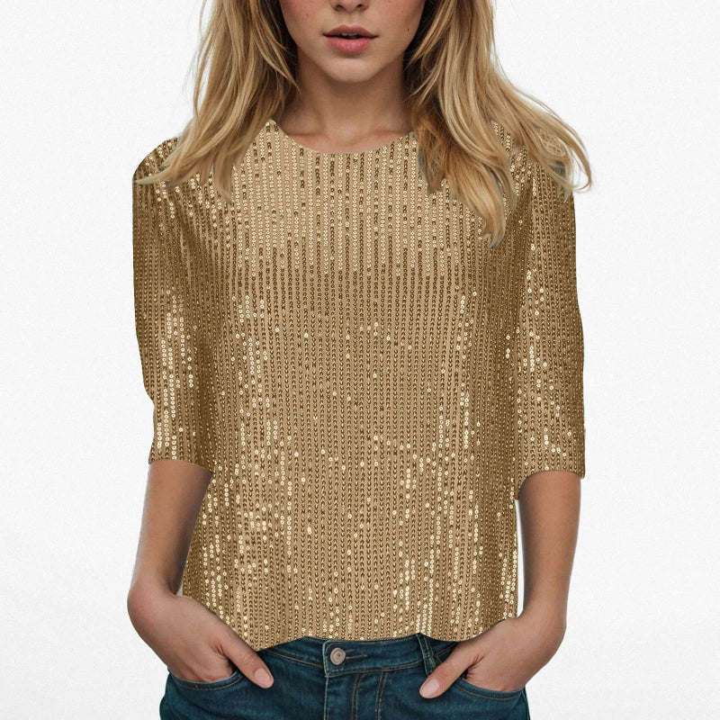 Person wearing a gold sequin top on a white background