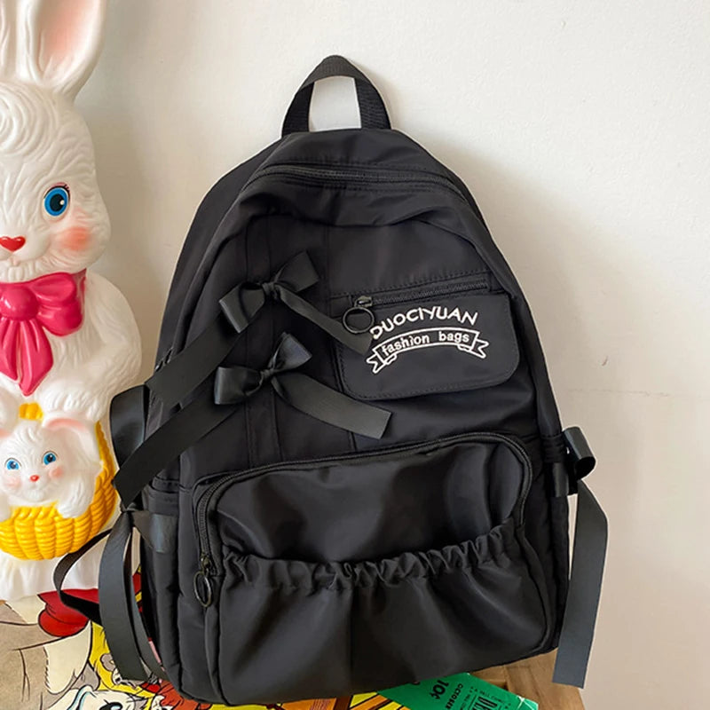Black backpack with visible brand logo on a light background