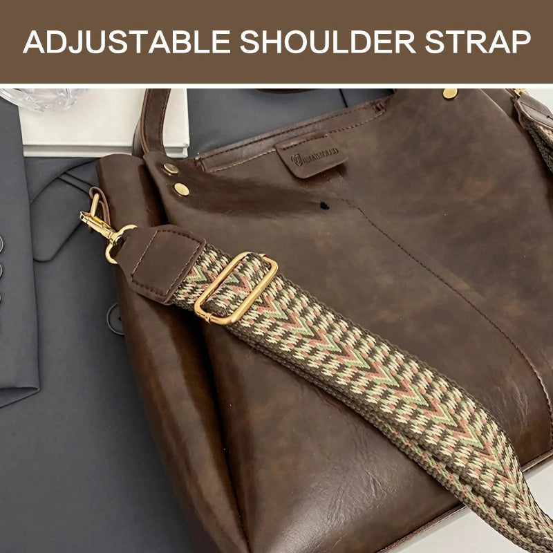 Brown leather bag with an adjustable shoulder strap featuring a gold buckle.