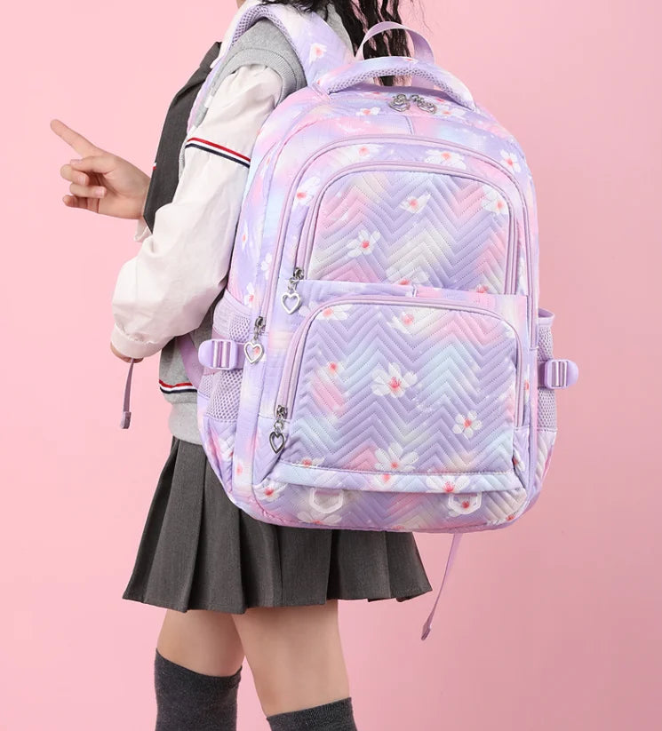 Person wearing a pastel patterned backpack on a pink background