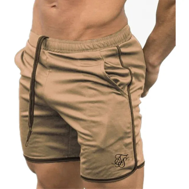 Beige shorts with black piping on a white background