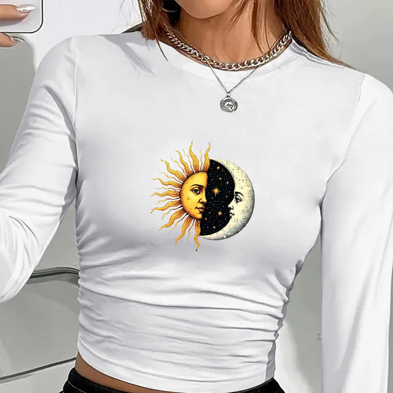 White long-sleeve shirt with sun and moon design worn by a person.