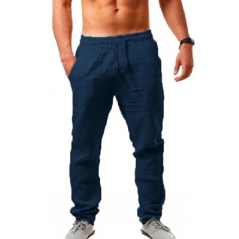 Navy blue jogger pants worn by a person on a white background