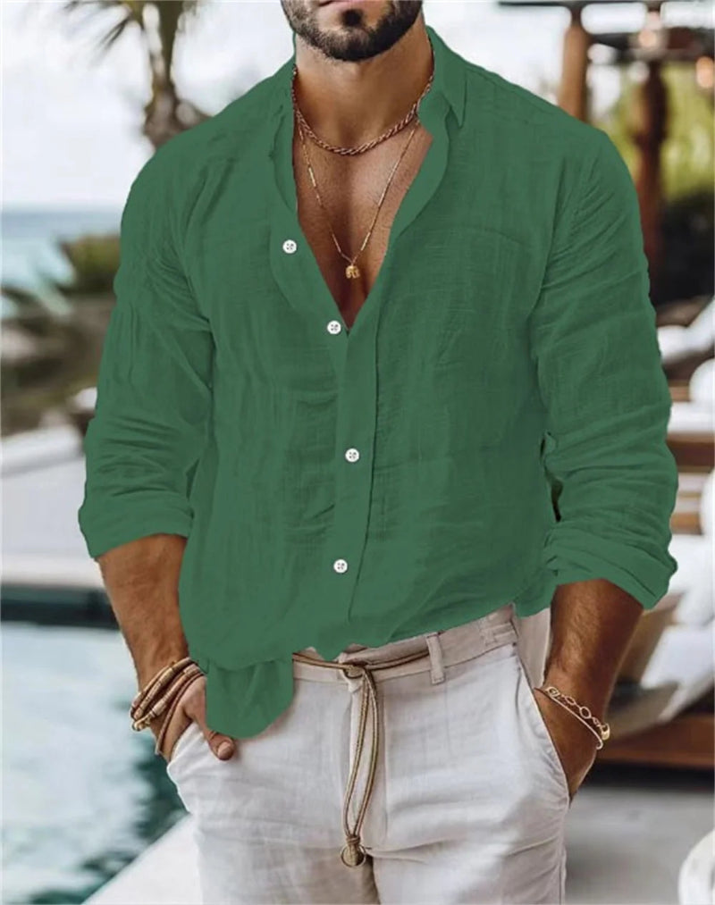 Man wearing a green button-up shirt and light pants by a poolside.