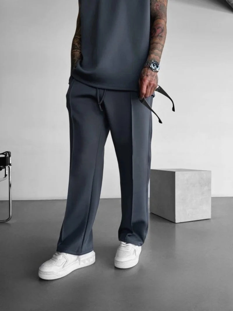 Men’s casual solid-color pants with elastic waist, drawstring closure, and side pockets dark gray