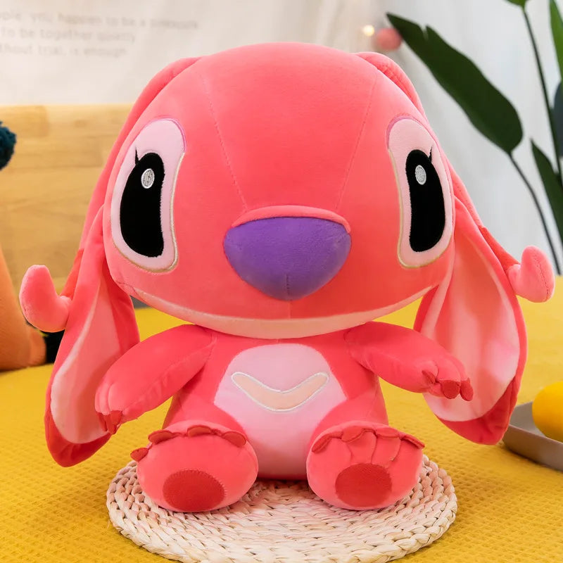 Pink plush toy with a purple nose on a yellow surface