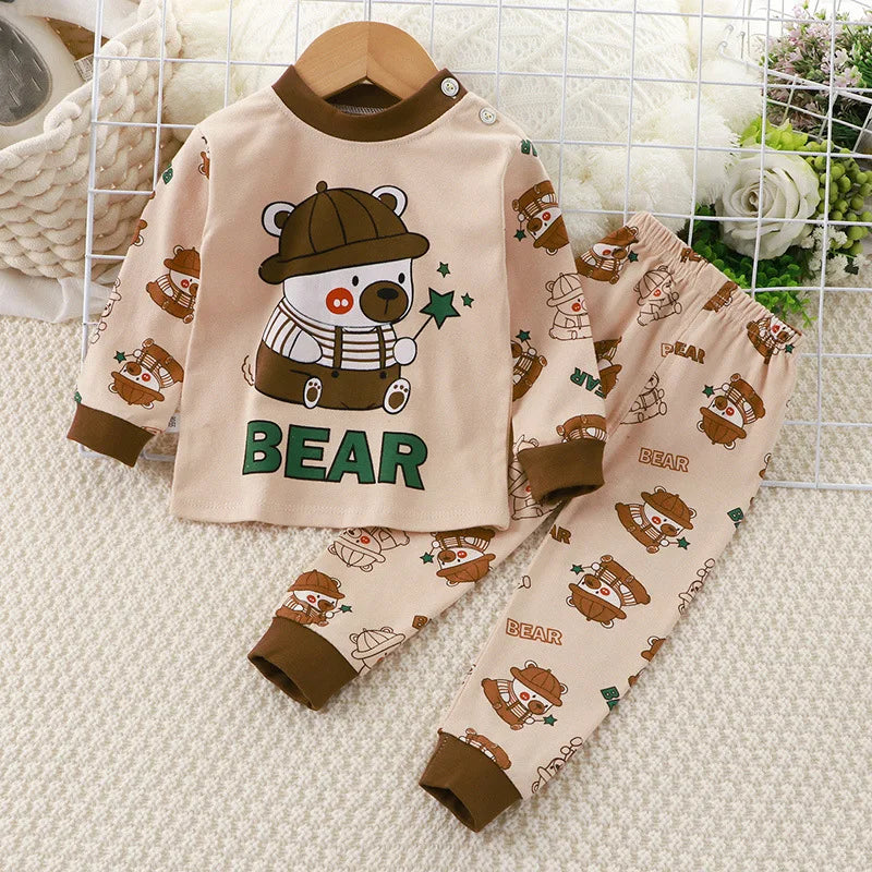 A baby girl's outfit set with long sleeves, featuring Minnie Mouse character designs, hanging on a wooden hanger.